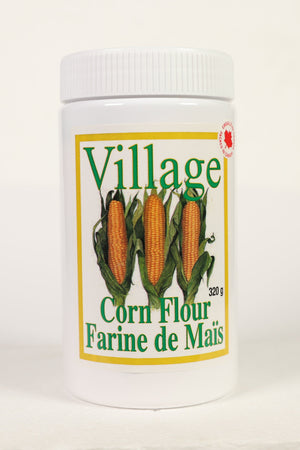 A container of Village brand corn flour, labeled 'Corn Flour' and 'Farine de Mais' with a net weight of 320 grams.