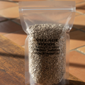 A clear plastic bag filled with raw sunflower seeds. The bag has a label that includes the brand 'Village Foods' and the product name 'Sunflower Seeds Raw.