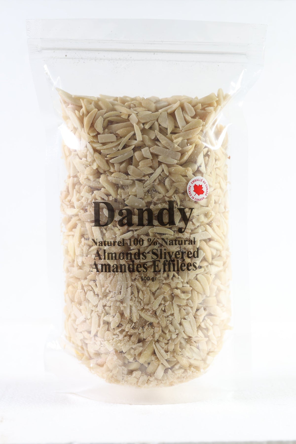A clear plastic package containing slivered almonds, with a label displaying the brand 'Dandy' and the words 'Almonds Silvered 1kg - Product of Canada'.